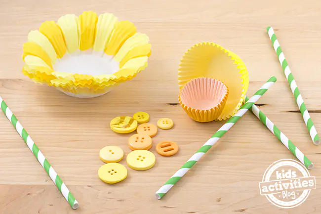 Cupcake Liner Daffodils craft supplies- flower cupcake liners, yellow cup cake liners, mini cupcake liners, yellow buttons, and green and white straws