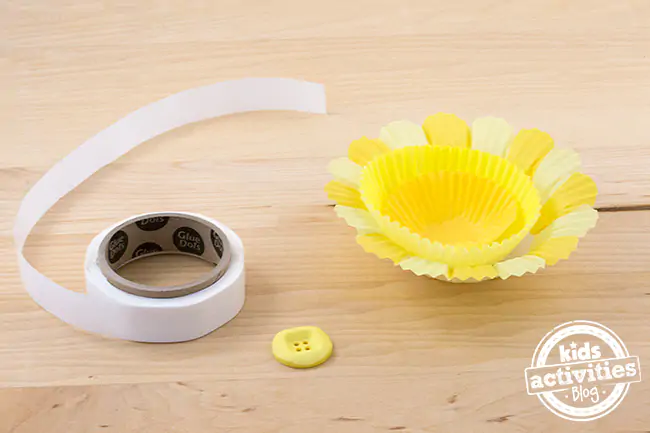 Cupcake Liner Daffodils- flora cupcake liner, yellow cupcake liner, and mini cupcake liner, and glue dots, and a yellow button