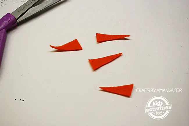 Step 3 - cutting orange felt into snowman carrot noses for Snowman Craft from Foam Cups