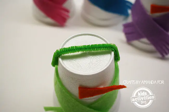 Step 4 - adding the top of the earmuff pipe cleaner for Snowman Craft from Foam Cups