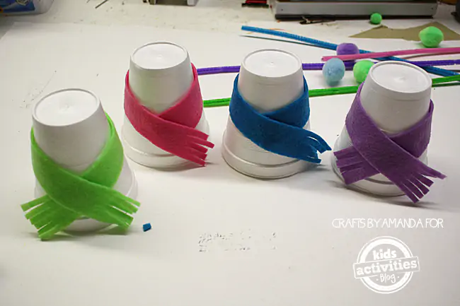 Step 2 - wrapping cut felt around styrofoam cups for Snowman Craft from Foam Cups