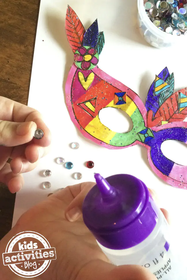 Decorate your own Mardi Gras Mask with glue, and fake gems.