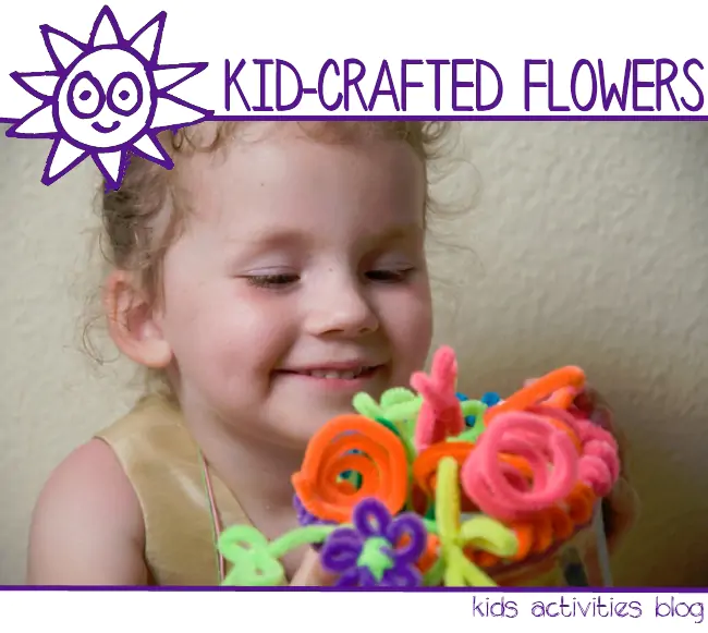 Easy pipe cleaner flowers craft for kids - girl holding a pipe cleaner flower bouquet she made
