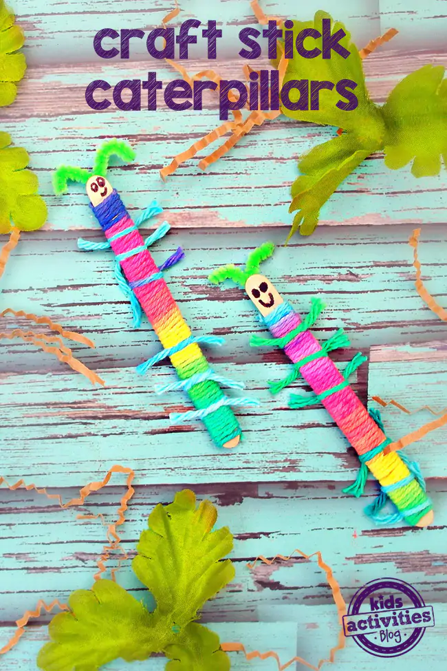 Craft Stick Caterpillars craft - yarn and popsicle stick caterpillars finished in bright colors on a blue background - Kids Activities Blog