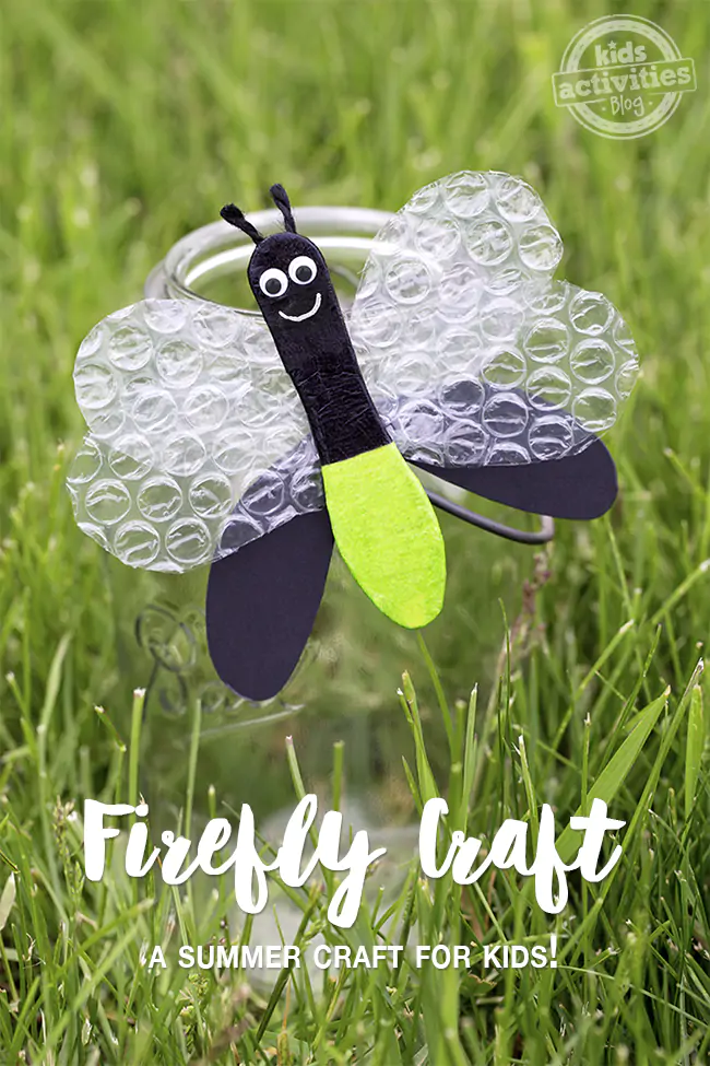 Firefly craft for kids, a black fire fly with a green bottom, and black and bubble wrap wings, and googly eyes on a jar in the grass.