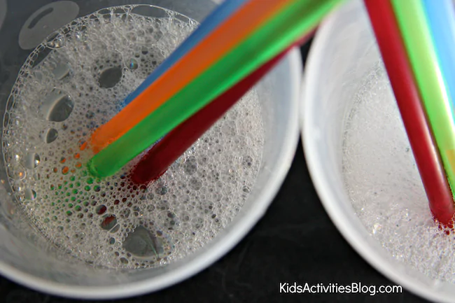 DIY Bubble Shooter Wands in homemade bubble solution ready to blow bubbles